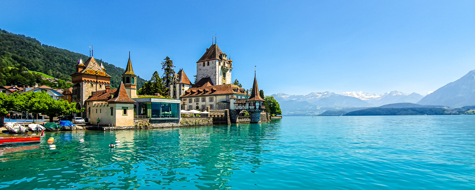 SummerWater Image of blue water and old city with mountains in the background